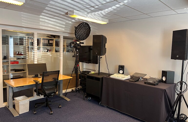 Copenhagen training facility with presentation display, tables, and audio equipment.