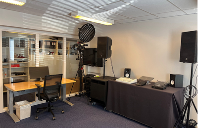Copenhagen training facility with presentation display, tables, and audio equipment.