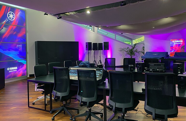 Croissy-Beaubourg training facility with Yamaha audio equipment, display screen, and purple lighting.