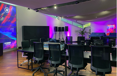 Croissy-Beaubourg training facility with Yamaha audio equipment, display screen, and purple lighting.