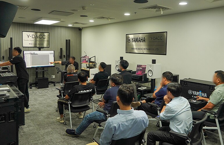 Ho Chi Minh City training facility with attendees seated during an audio training session.