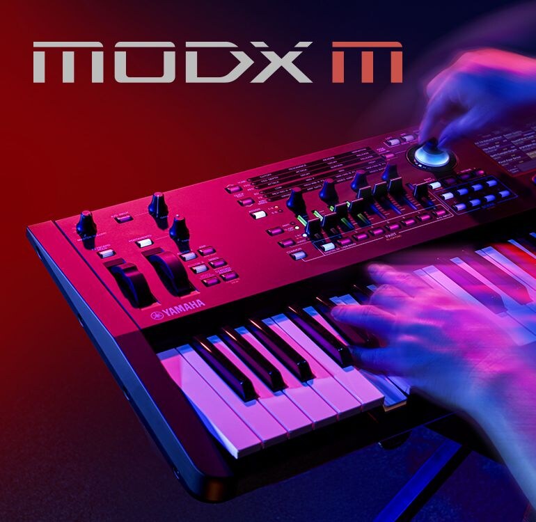 Artistic visual focusing on hands playing a synthesizer in a performance scene